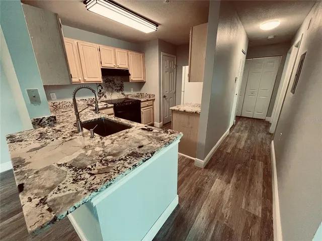 a kitchen with a sink stove and refrigerator