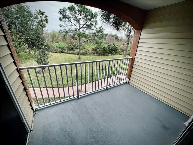 a view of a balcony with wooden floor