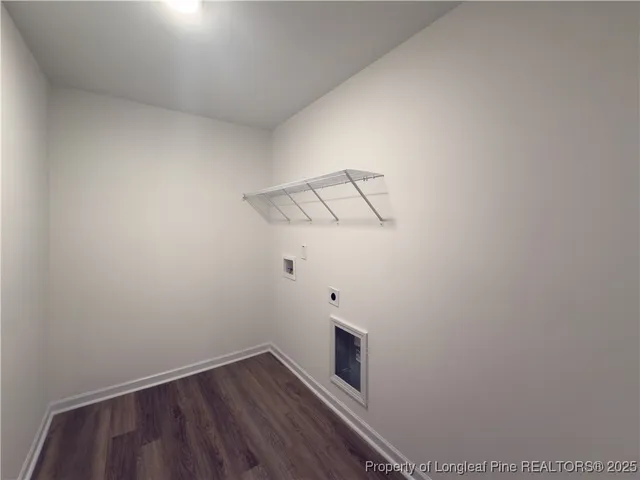 a view of a room with wooden floor and white walls