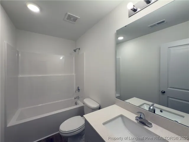 a bathroom with a sink toilet tub and shower