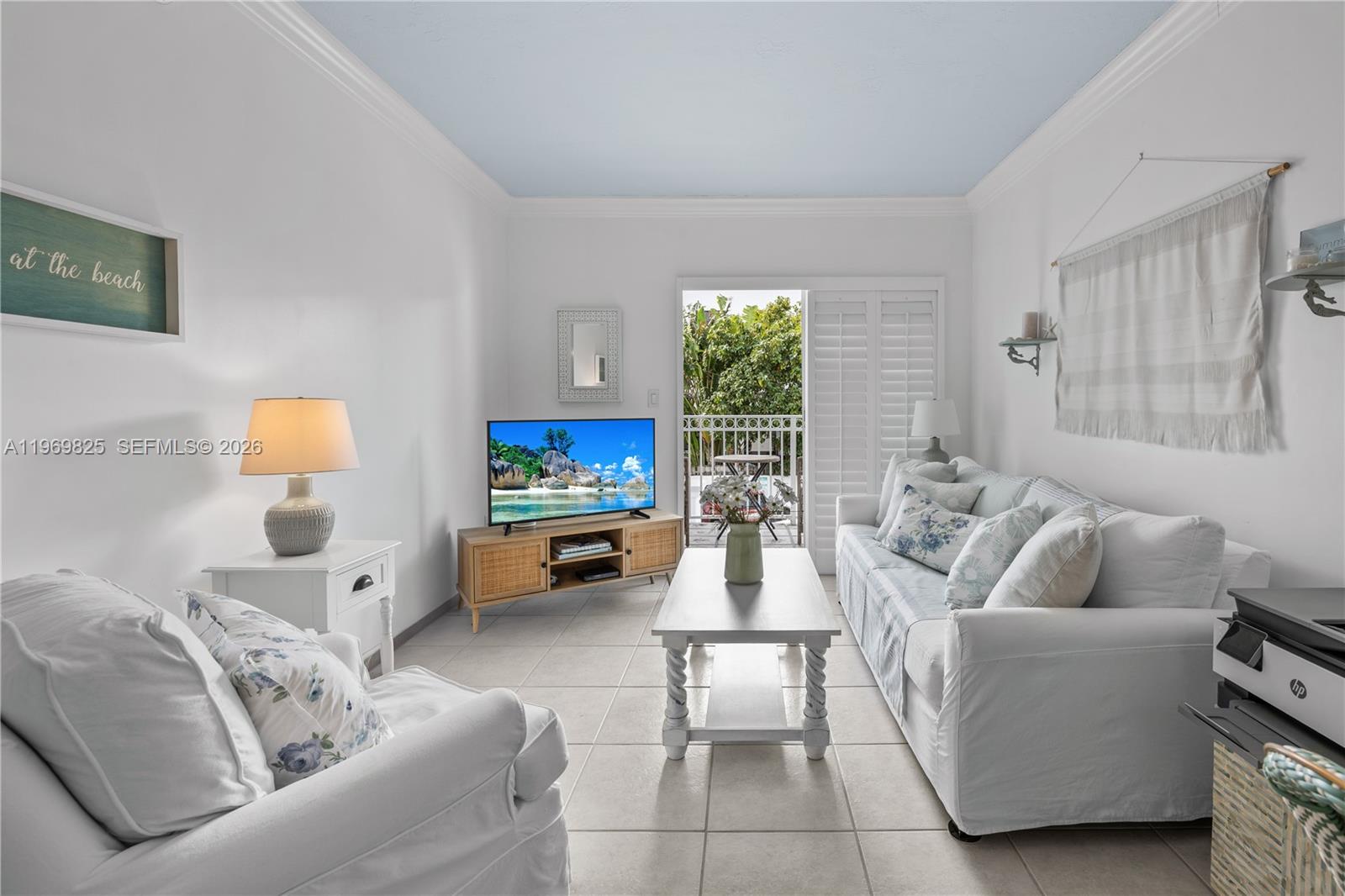 290 Sunrise Drive, Unit 2L Key Biscayne, FL 33149 - Photo 11 of 16 a living room with furniture and a flat screen tv