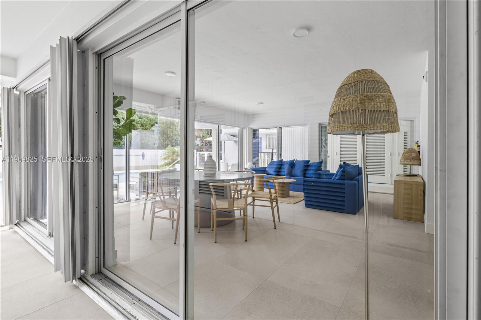 290 Sunrise Drive, Unit 2L Key Biscayne, FL 33149 - Photo 13 of 16 a living room with a couch and a table