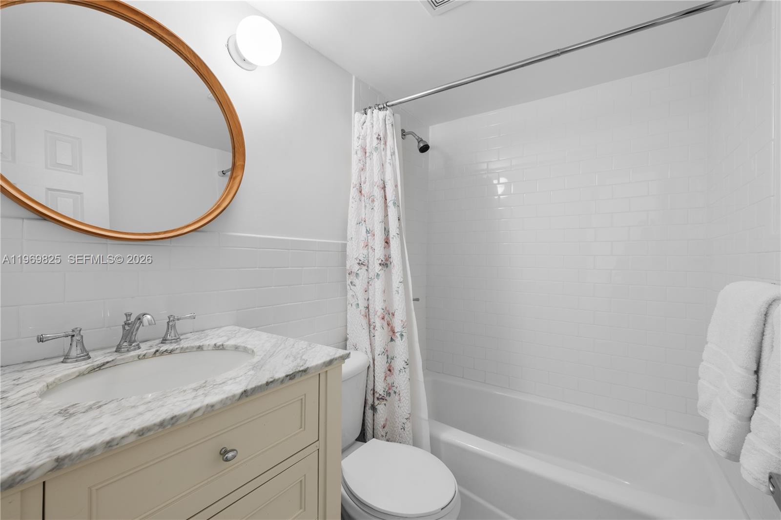 290 Sunrise Drive, Unit 2L Key Biscayne, FL 33149 - Photo 14 of 16 a bathroom with a granite countertop sink toilet and a mirror