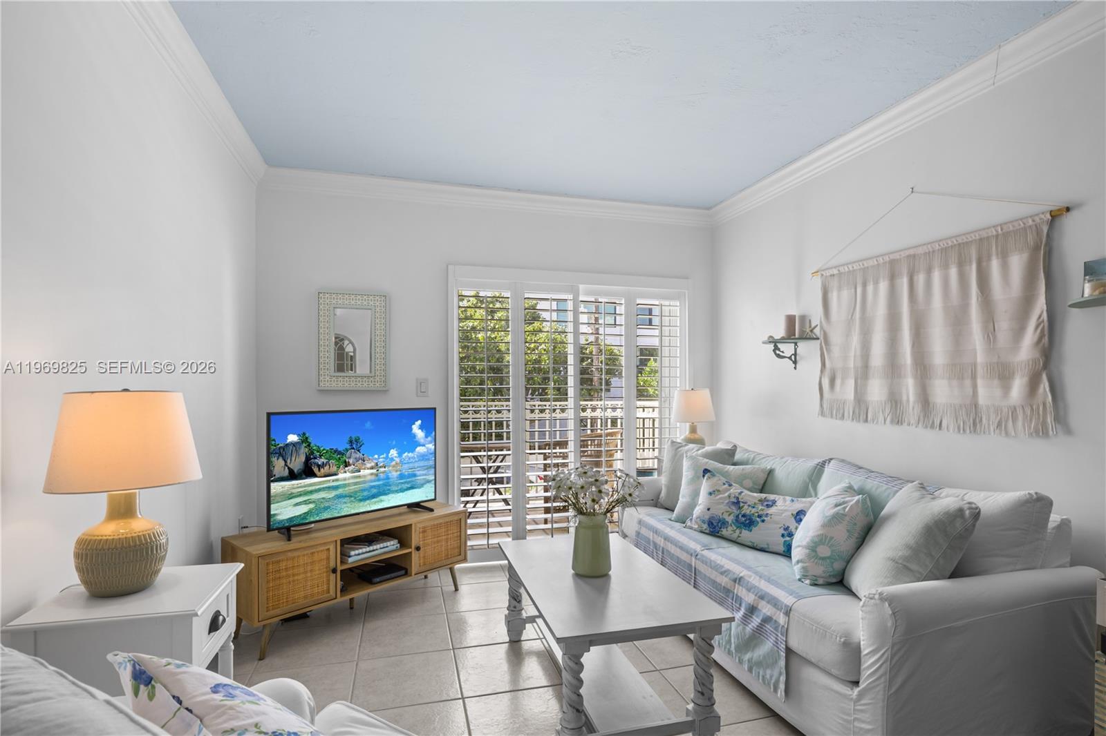 290 Sunrise Drive, Unit 2L Key Biscayne, FL 33149 - Photo 2 of 16 a living room with furniture and a window