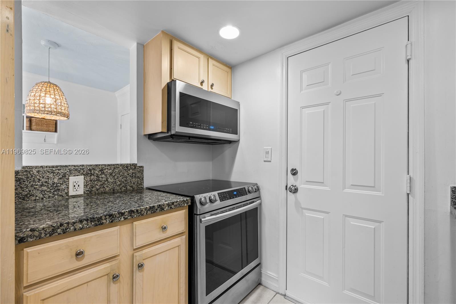 290 Sunrise Drive, Unit 2L Key Biscayne, FL 33149 - Photo 8 of 16 a kitchen with granite countertop white cabinets stainless steel appliances and a sink