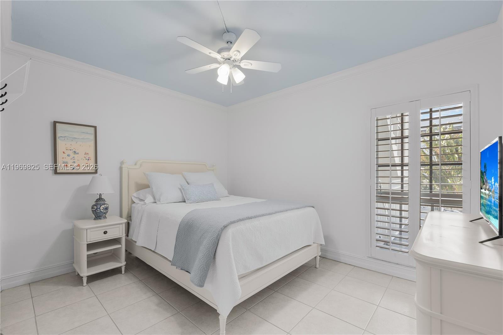 290 Sunrise Drive, Unit 2L Key Biscayne, FL 33149 - Photo 9 of 16 a bed room with a bed and a chandelier
