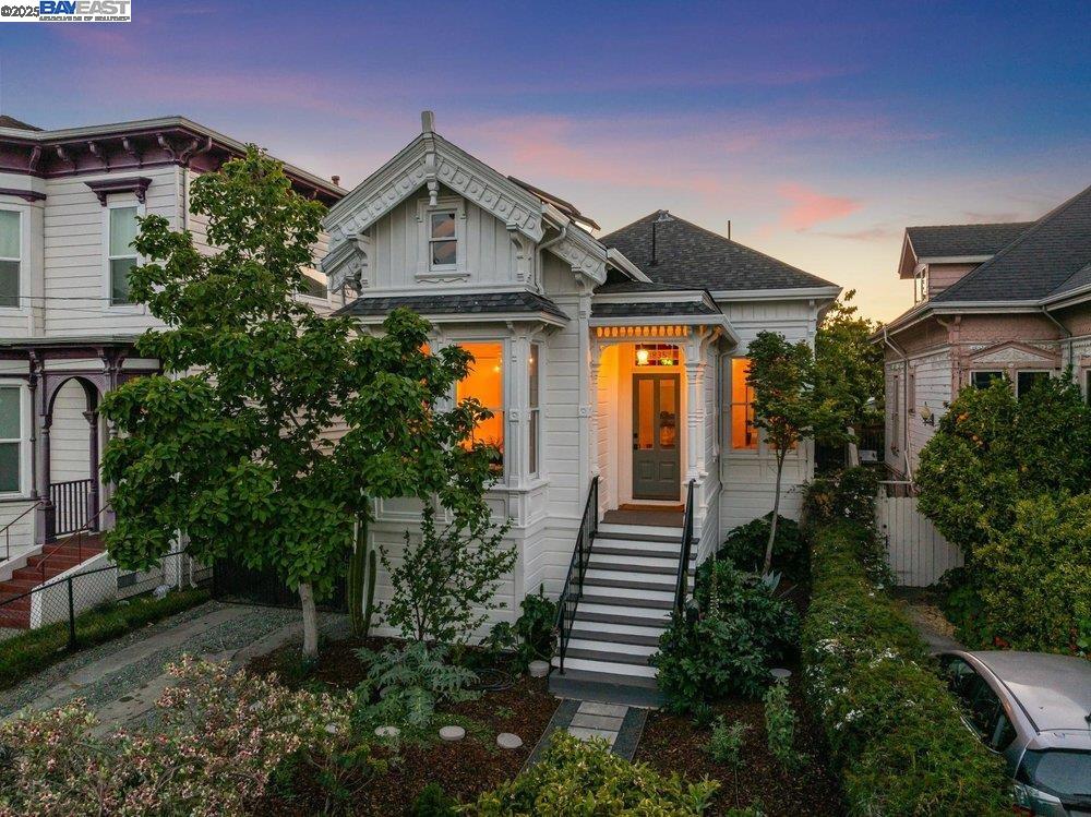 a front view of a house with a yard and potted plants