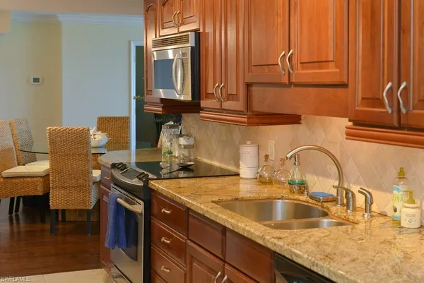 a kitchen with a sink and a stove