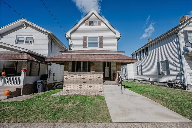 a front view of a house with a yard