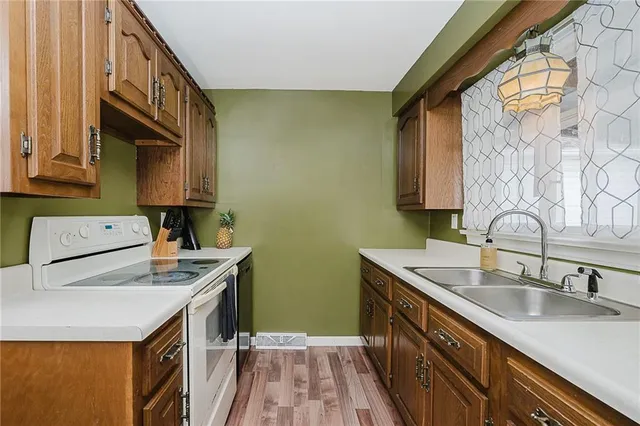 a kitchen with stainless steel appliances a sink a stove and a refrigerator