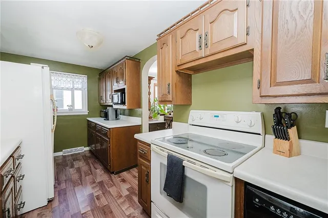 a kitchen with a sink a stove and cabinets