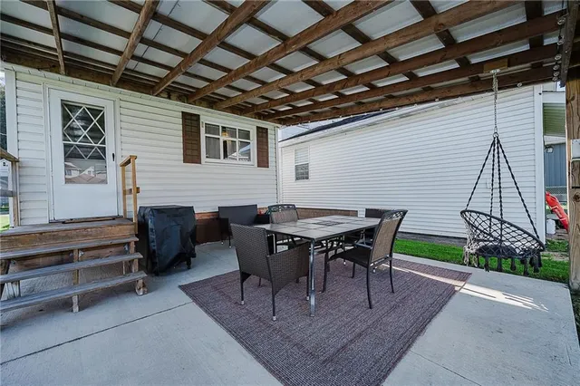 a view of a dinning table and chairs in the patio