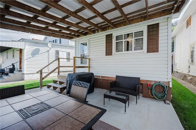 a backyard of a house with outdoor seating