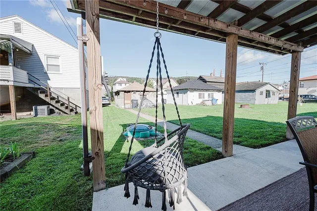 a view of an chair and table in backyard of the house