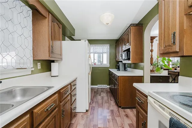 a kitchen with a sink stove and cabinets