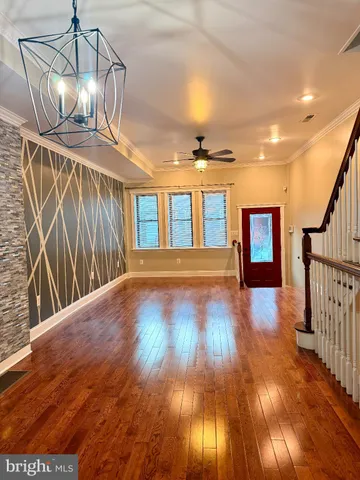 a view of entryway and hall with wooden floor