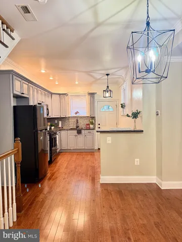 a view of kitchen and refrigerator