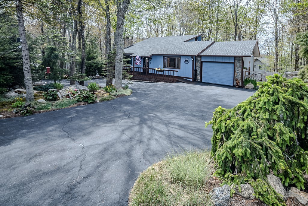 103-105 Upper Grouse Ridge Road Beech Mountain, NC 28604 - Photo 2 of 48 a view of a house with a yard and plants
