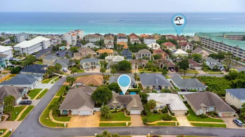 a view of a brick house with large windows and a table
