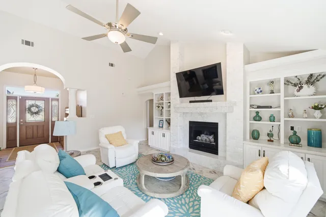 a view of a patio with a table and chairs under an umbrella