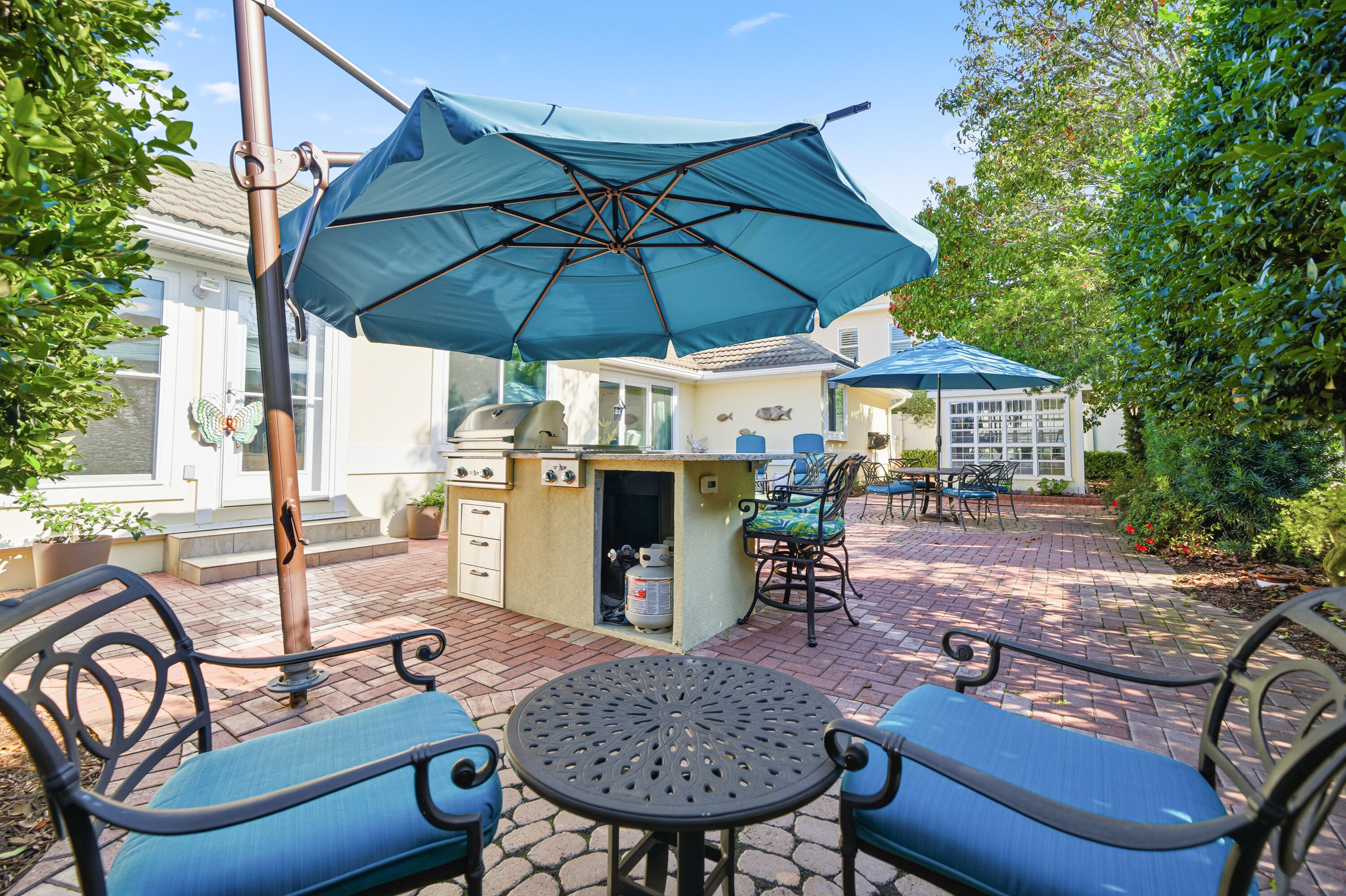 25 Tristram Way Miramar Beach, FL 32550 - Photo 18 of 50 a patio with a table and chairs under an umbrella