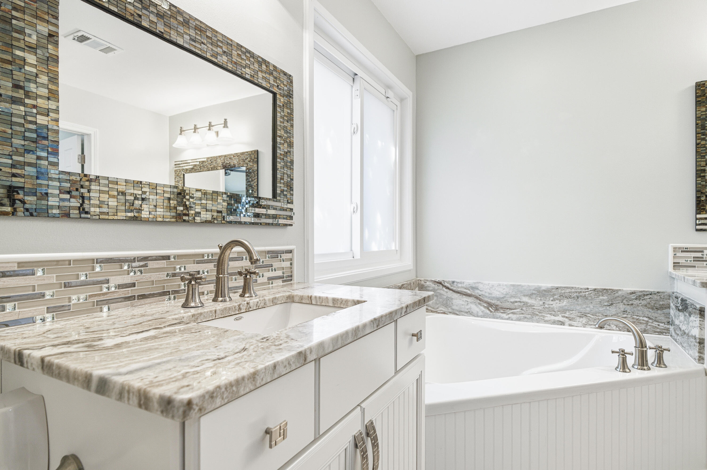 25 Tristram Way Miramar Beach, FL 32550 - Photo 40 of 50 a bathroom with a granite countertop sink and a mirror
