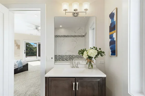 a bathroom with a sink a light fixture a vanity and a mirror