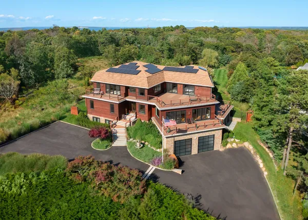 an aerial view of residential houses with outdoor space and street view