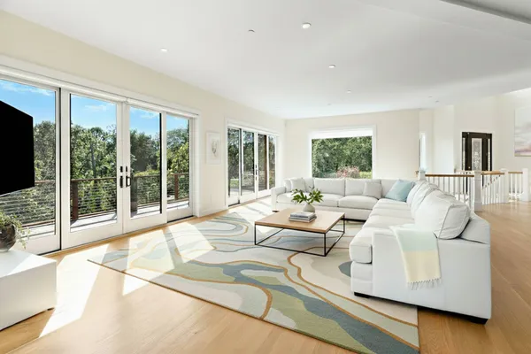 a view of swimming pool with seating area and trees in the background