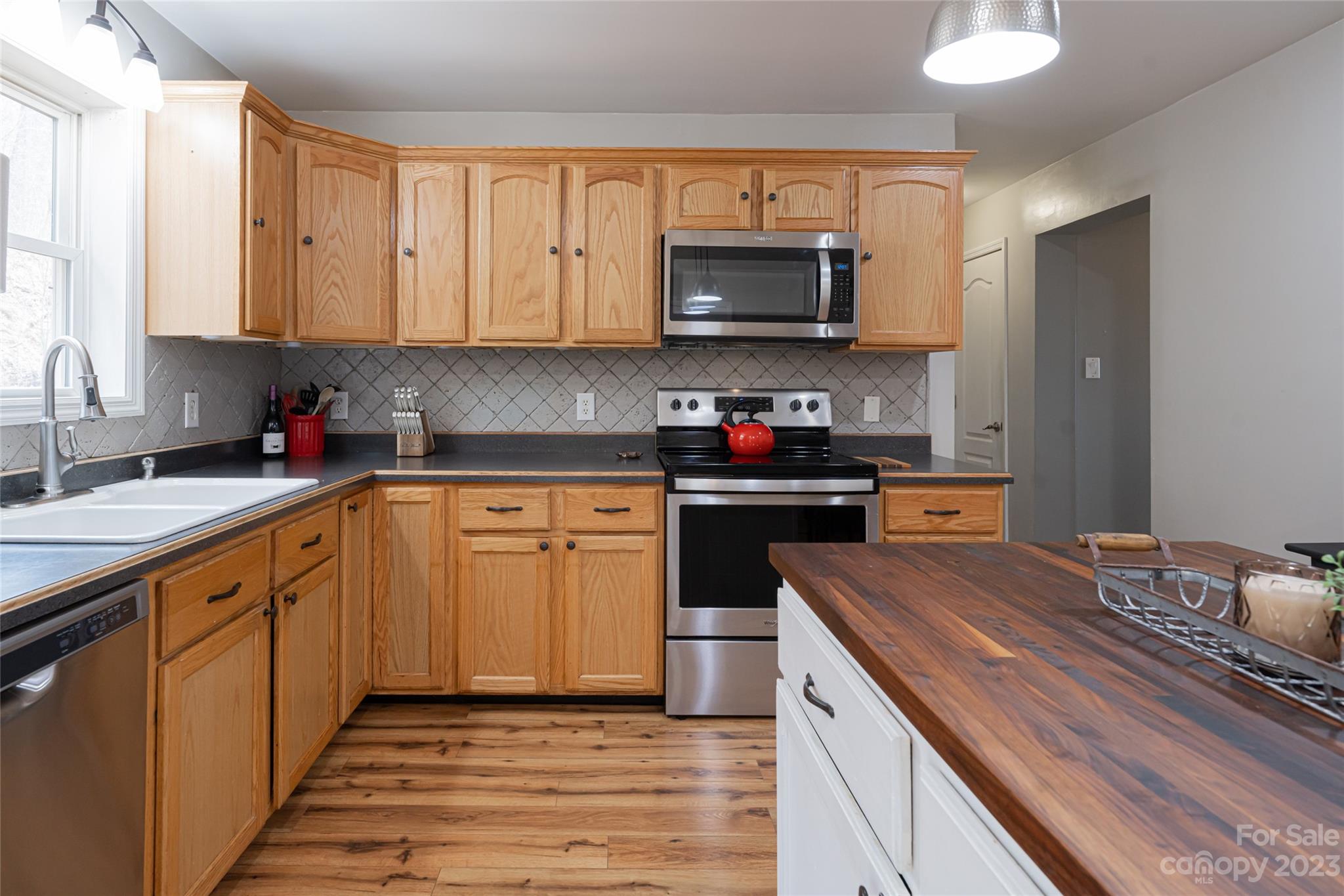 142 Blake Drive Canton, NC 28716 - Photo 29 of 44 a kitchen with a sink stove and microwave