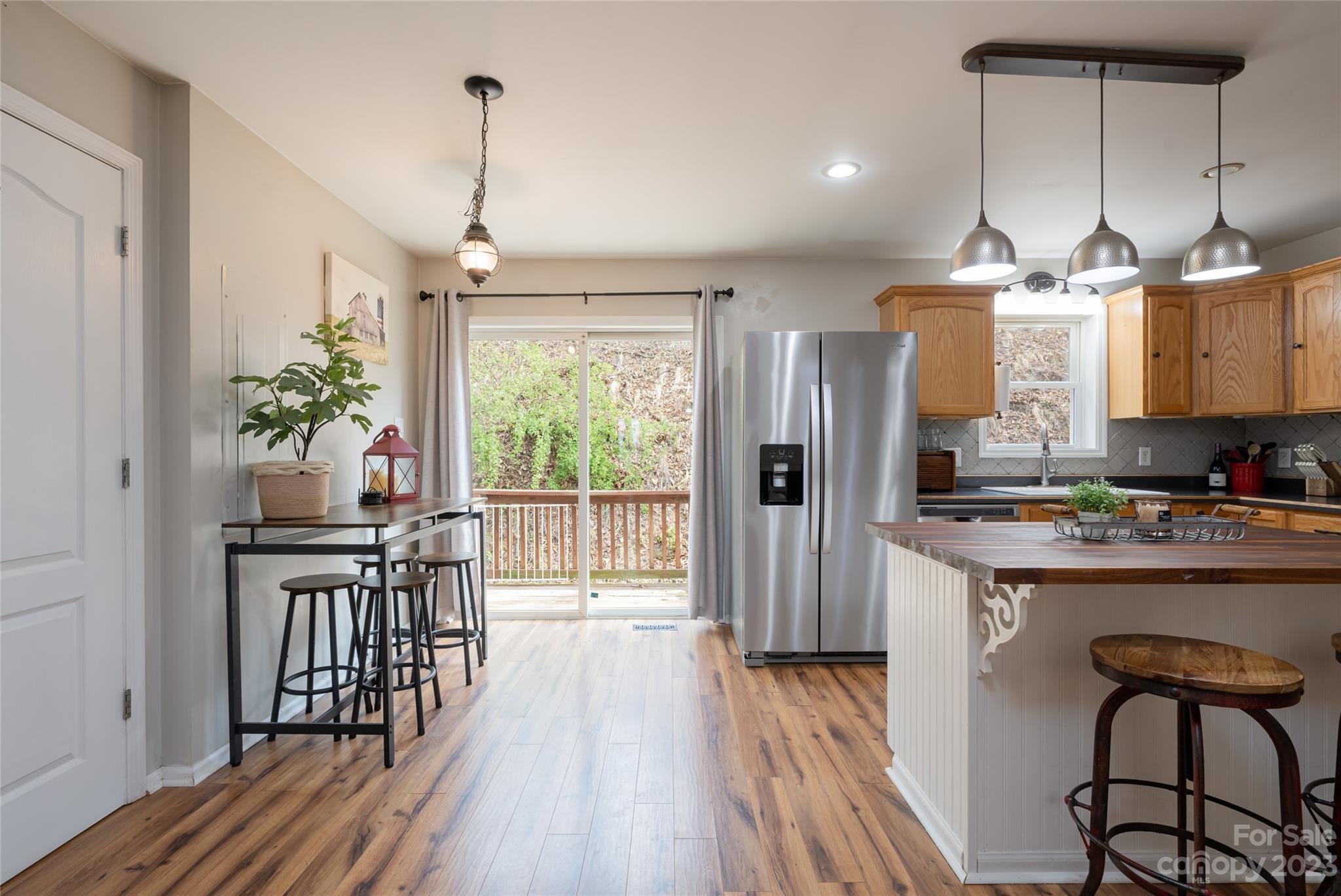142 Blake Drive Canton, NC 28716 - Photo 3 of 44 a kitchen with stainless steel appliances a dining table chairs stove and refrigerator