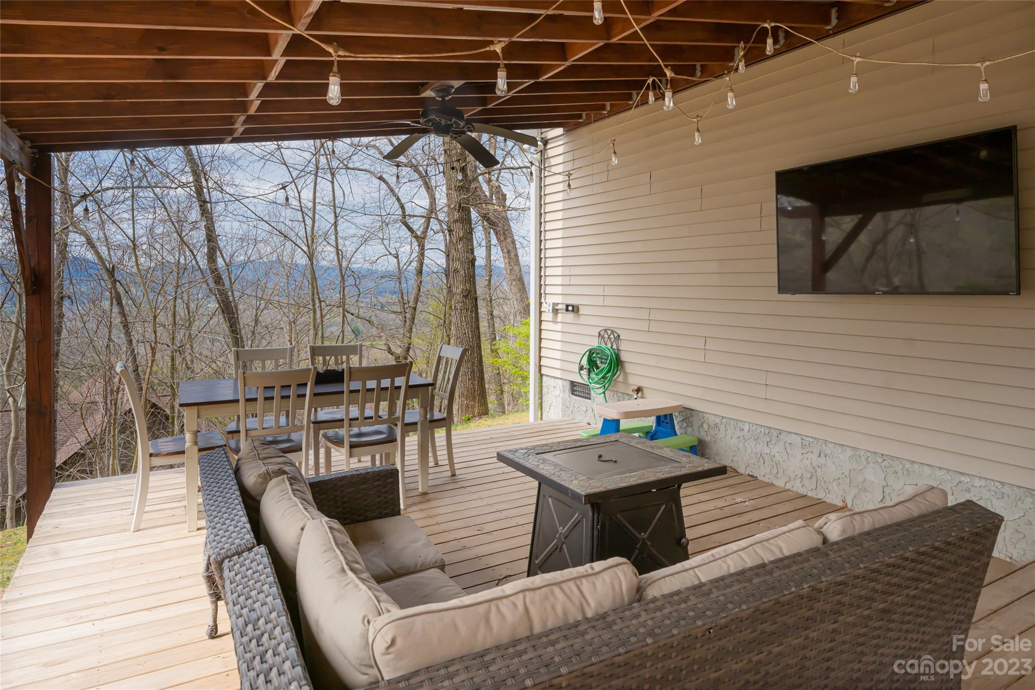 142 Blake Drive Canton, NC 28716 - Photo 32 of 44 a outdoor space with patio the couches and a dining table with the garden view