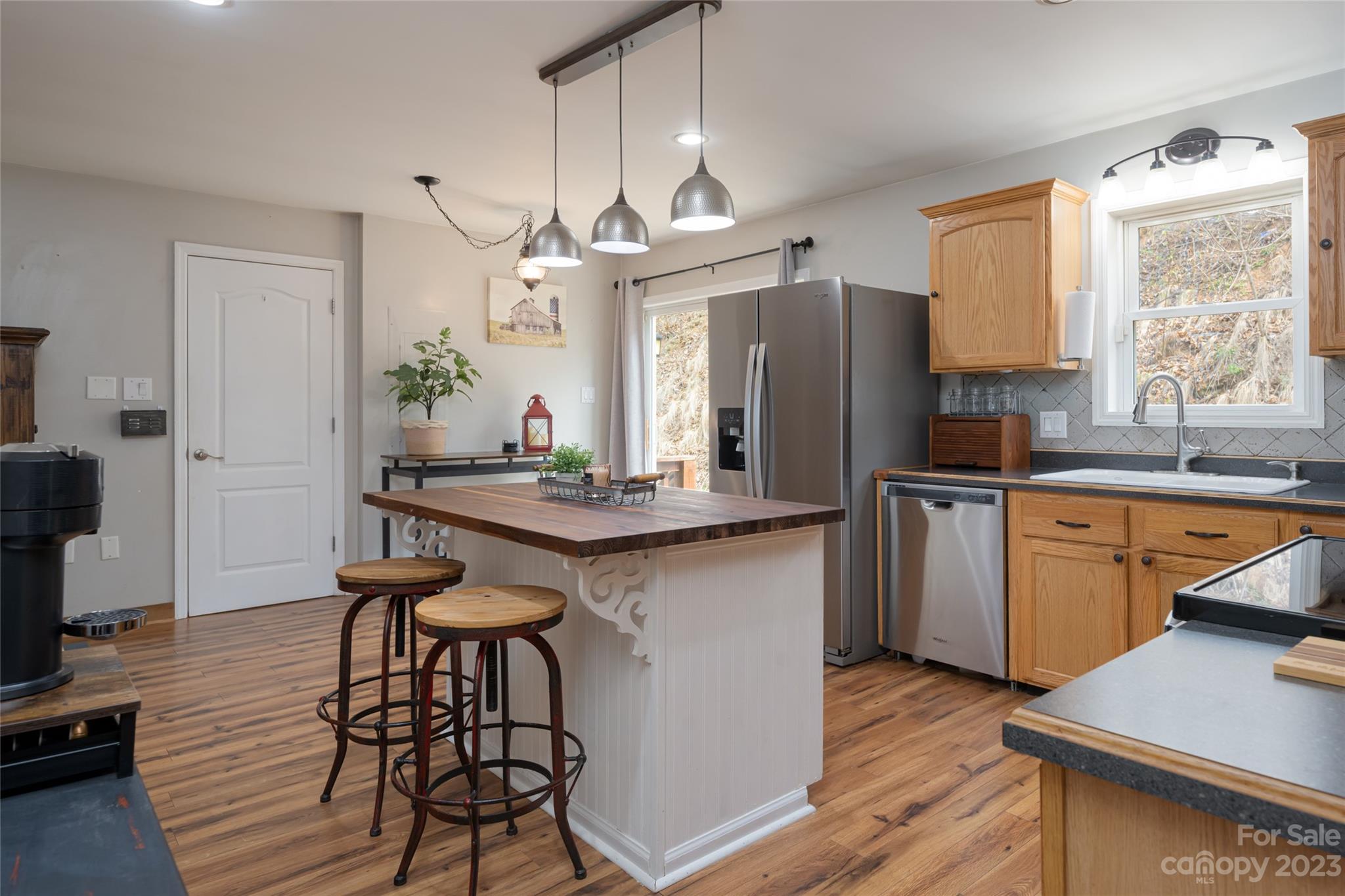 142 Blake Drive Canton, NC 28716 - Photo 4 of 44 a kitchen with granite countertop a sink cabinets and wooden floor