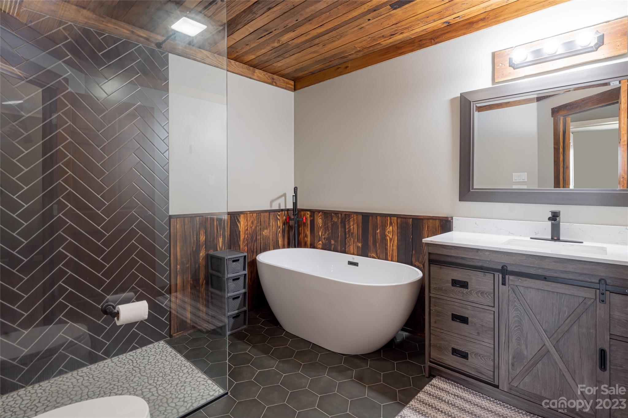 142 Blake Drive Canton, NC 28716 - Photo 9 of 44 a spacious bathroom with a bathtub and a sink