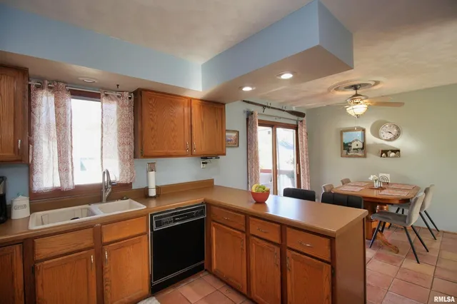a kitchen with a sink cabinets and window