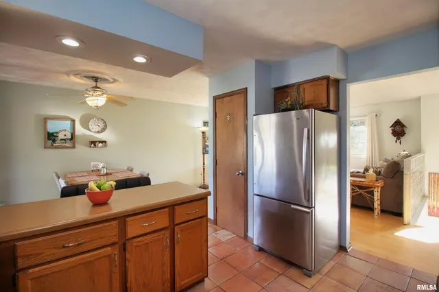 a kitchen with stainless steel appliances a refrigerator and microwave