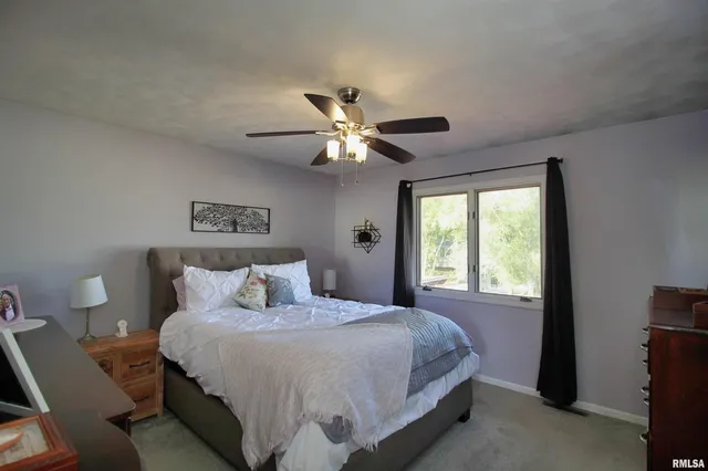 a bedroom with a large bed and a large window