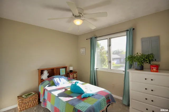 a bedroom with a bed and a potted plant