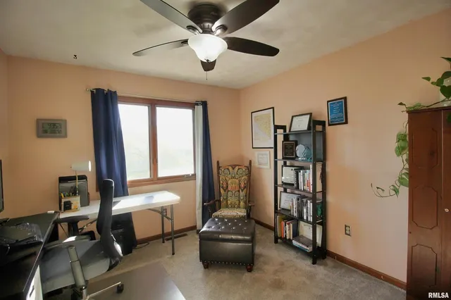 a living room with furniture a chandelier fan and a window