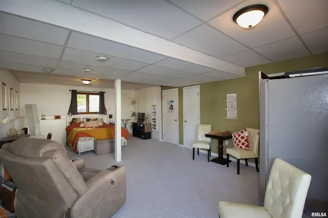 a living room with furniture and a lamp