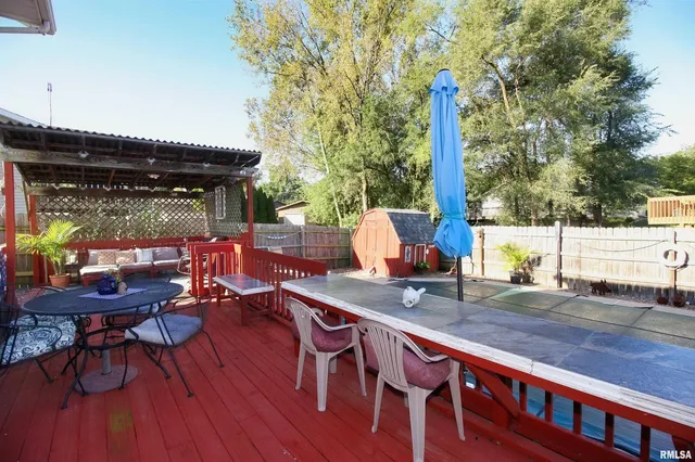 a view of a patio with a table and chairs