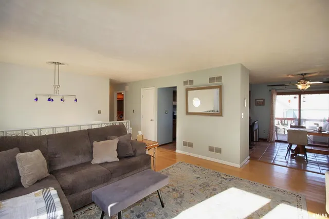 a living room with furniture and wooden floor