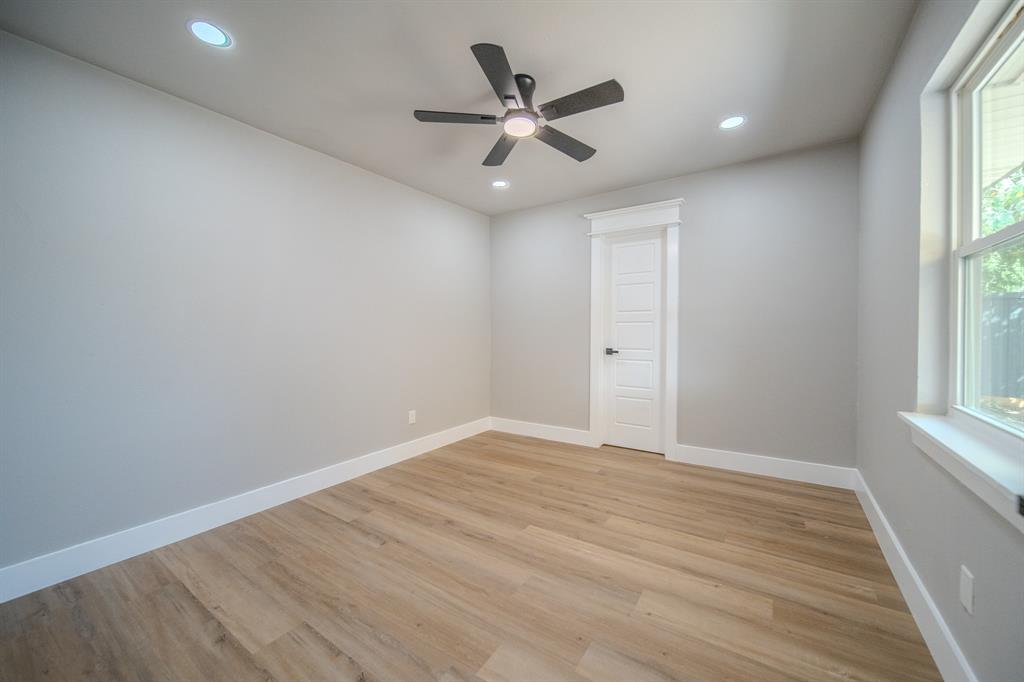 6320 Old Ox Road Dallas, TX 75241 - Photo 11 of 17 Recessed lighting, wood-finish flooring, ceiling fan, white trim, and a paneled door with dark hardware