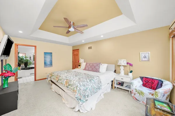 a bedroom with a bed and a chandelier