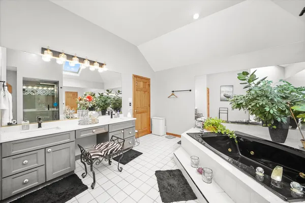 a large white kitchen with a large window
