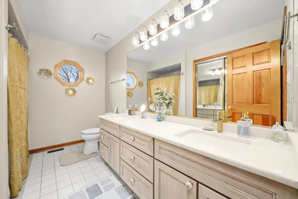 a bedroom with bed and a chandelier