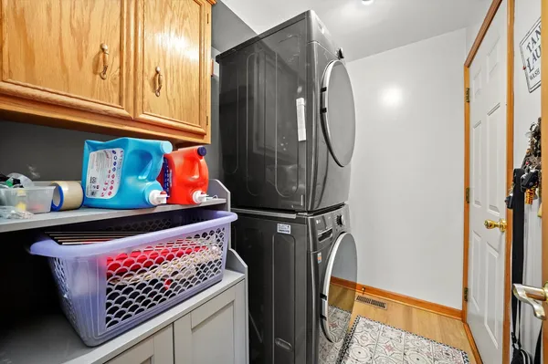 a view of a roof deck with table and chairs a barbeque with wooden floor and fence