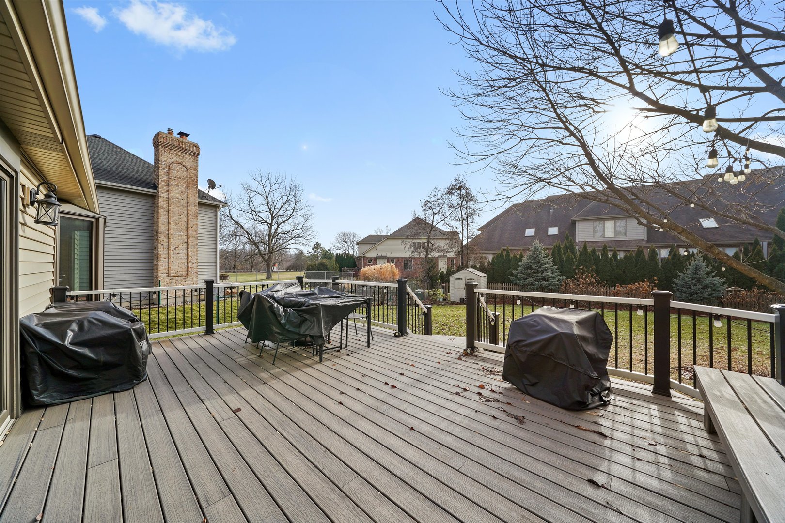 18 Newgate Avenue Naperville, IL 60565 - Photo 27 of 31 a view of a roof deck with table and chairs a barbeque with wooden floor and fence