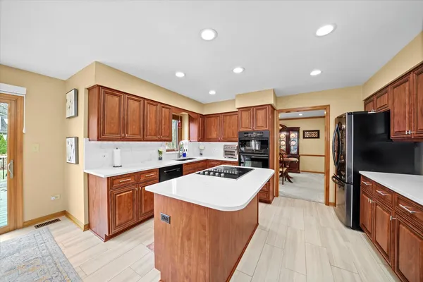 a kitchen with stainless steel appliances granite countertop a stove oven and a refrigerator