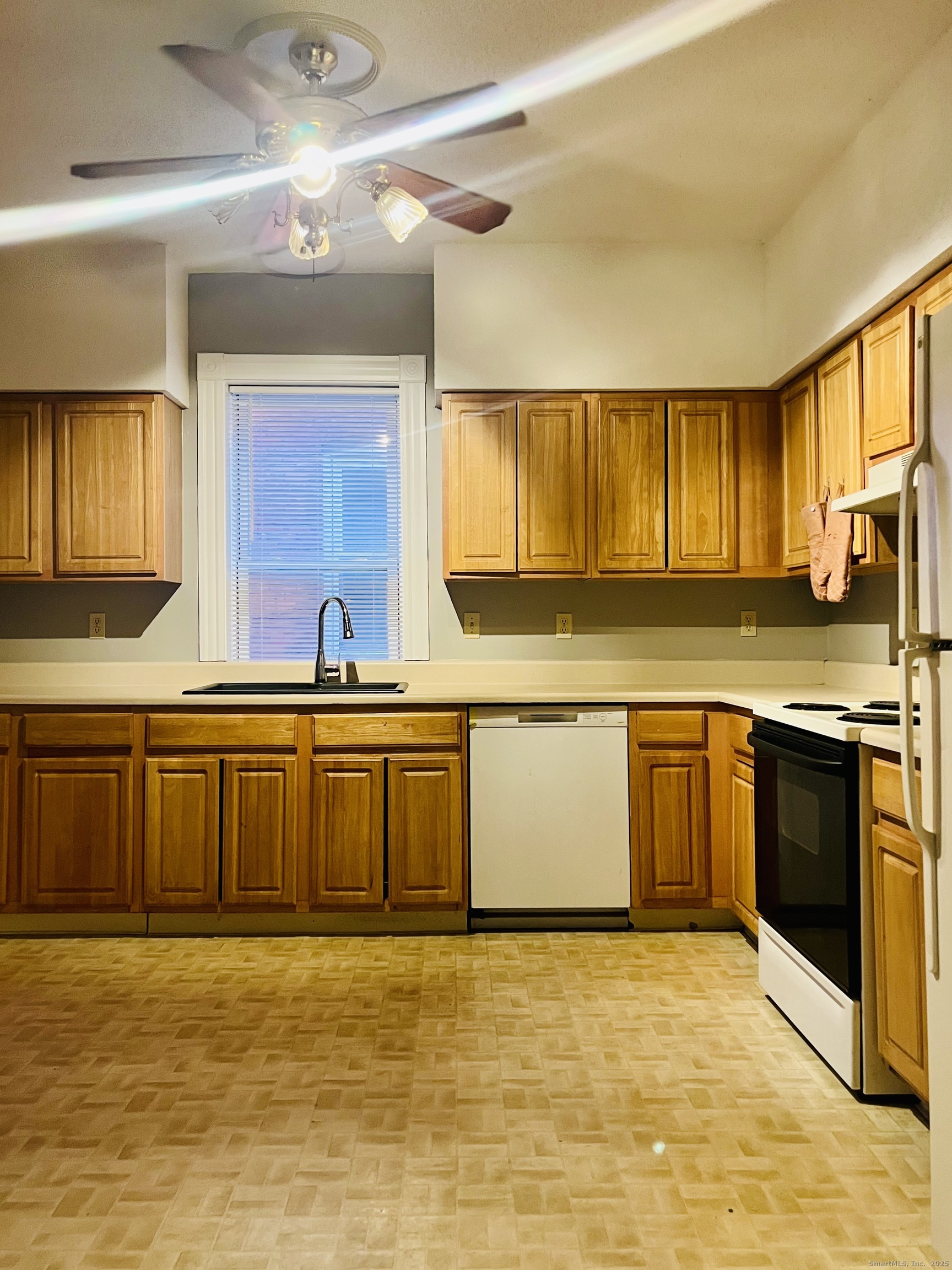 24 Mortson Street Hartford, CT 06106 - Photo 3 of 16 a large kitchen with stainless steel appliances granite countertop a sink a stove cabinets counter space and a window